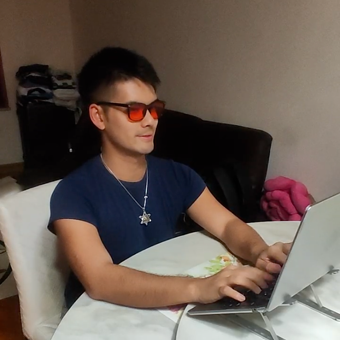 Working On laptop Using Red-Lensed Blue Light Blocking Glasses