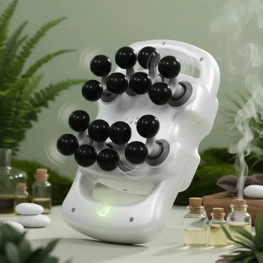 White handheld head massager with black massage balls in a relaxing spa setting with essential oils and steam