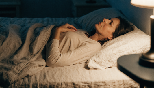 Woman lying awake in bed at night, tired but unable to fall asleep