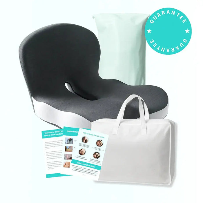 Ergonomic black and white seat cushion with back support, guarantee badge, informational leaflets, and white carrying bag