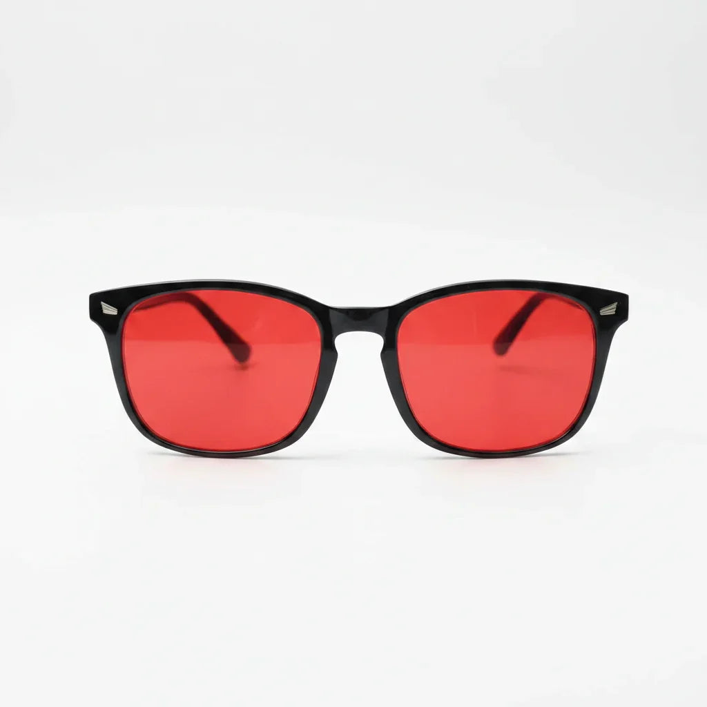 Red-tinted blue light glasses with black frames for better sleep and eye relief